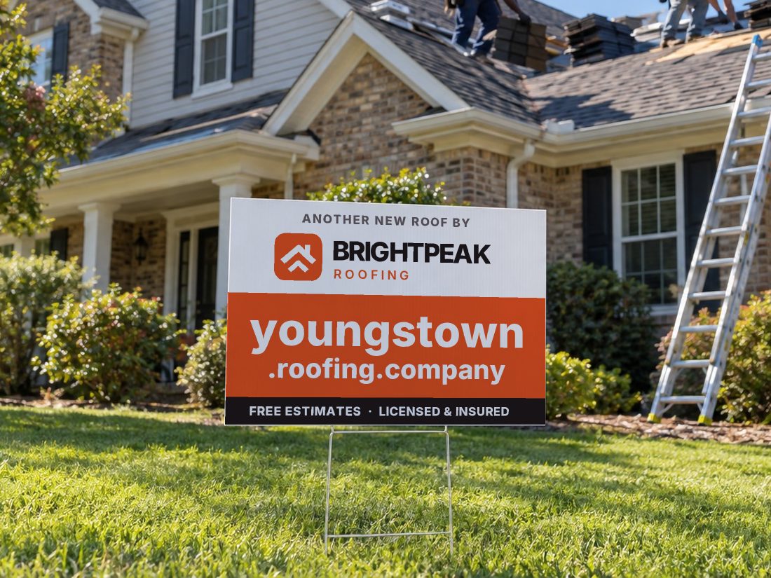 youngstown.roofing.company on a yard sign in front of a house getting a new roof